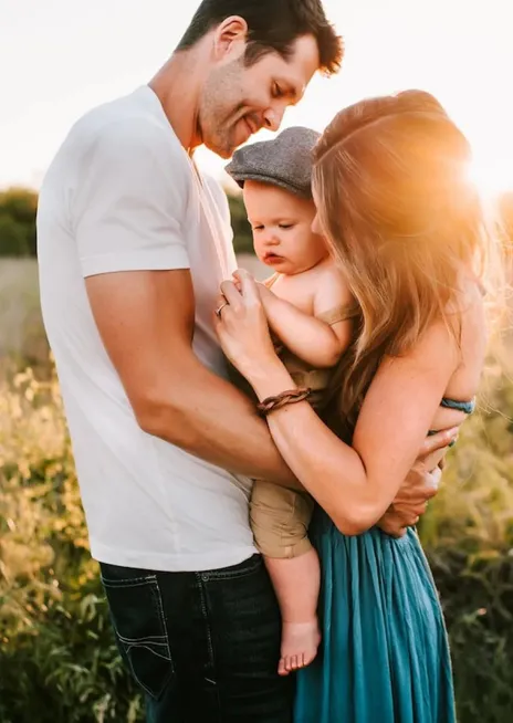 A couple holds their baby boy