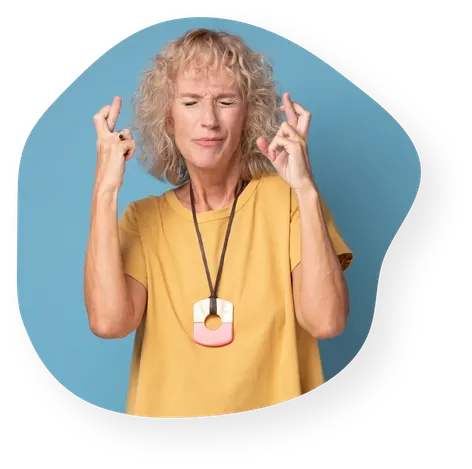 Woman with eyes tightly shut, crossing her fingers.